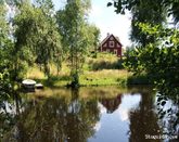 Cottage on the shore of a river in the forrest